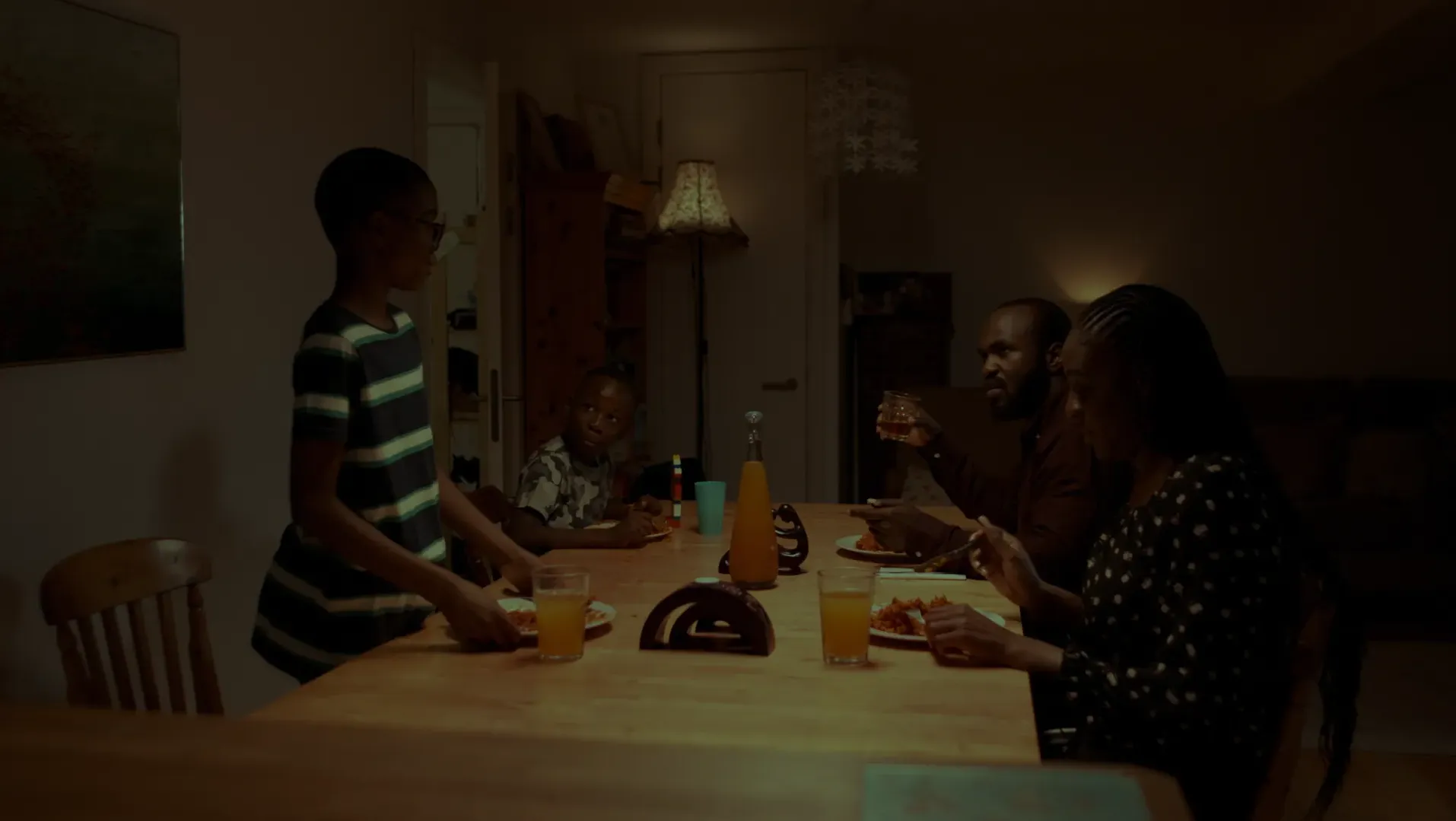 A black family eating dinner together.