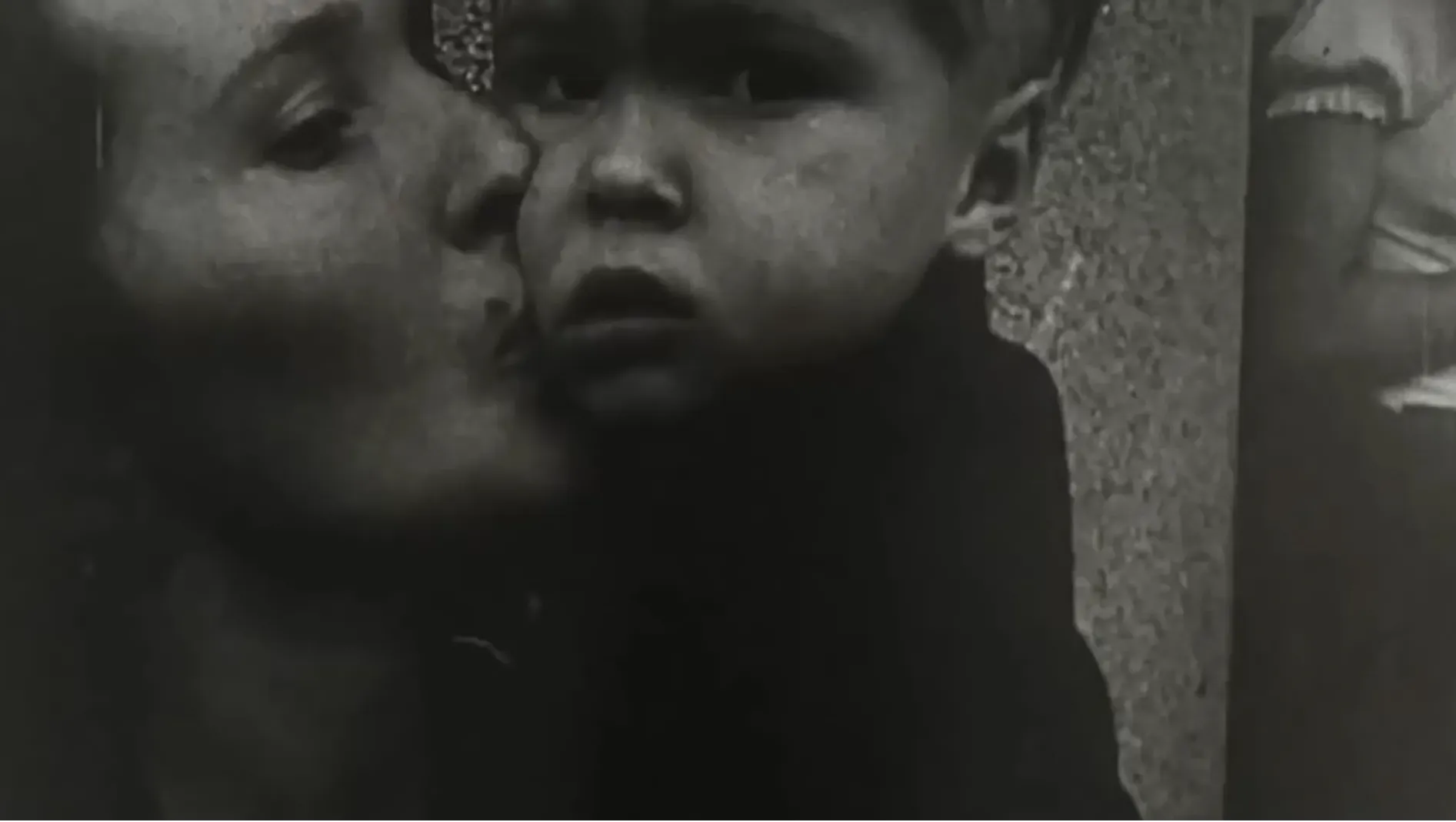 A French woman kisses her son before he is evacuated on a bus out of war-torn Paris during World War 2.