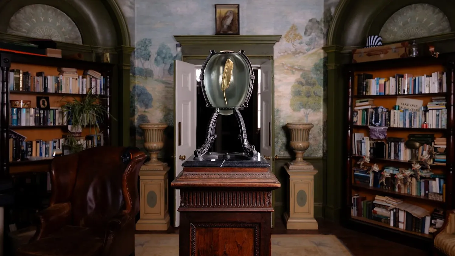 A glass egg with a golden feather in The Fletcher Apartments