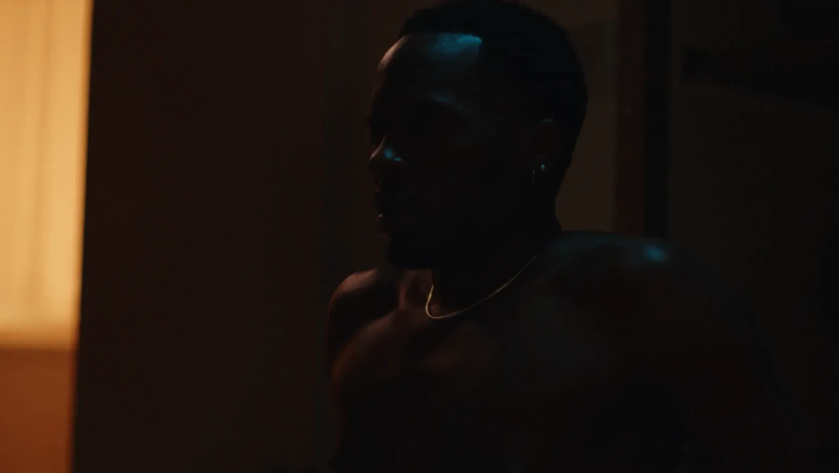 Close up of frightened man sat up in bed.