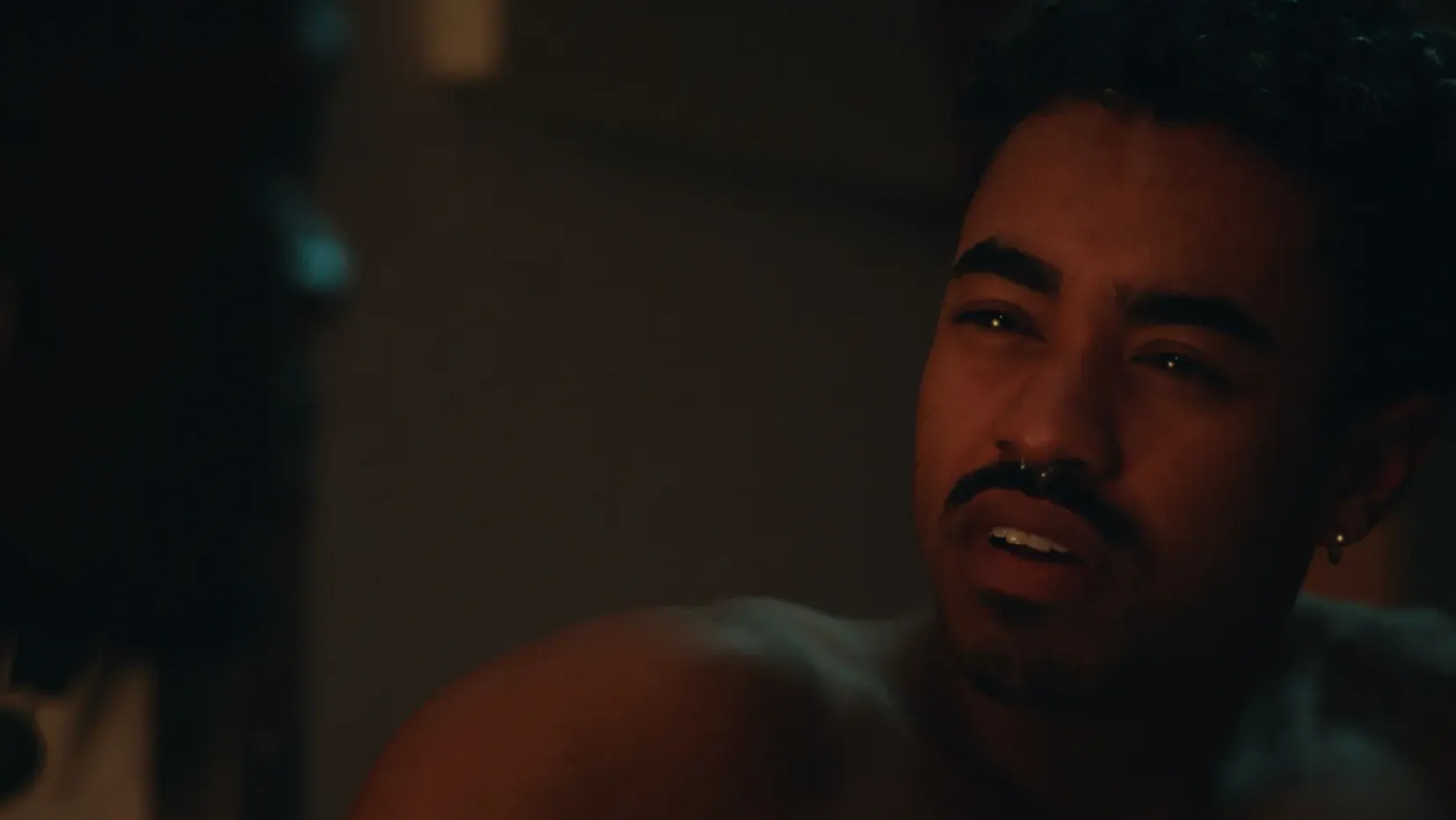 Close of a man glaring at another man.