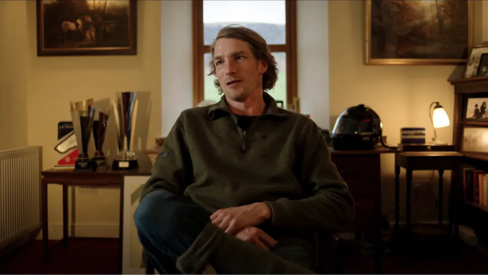 A man seated inside is speaking