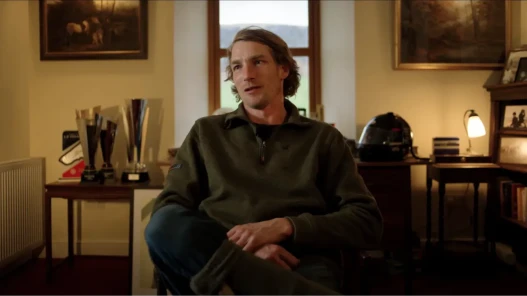 A man seated inside is speaking