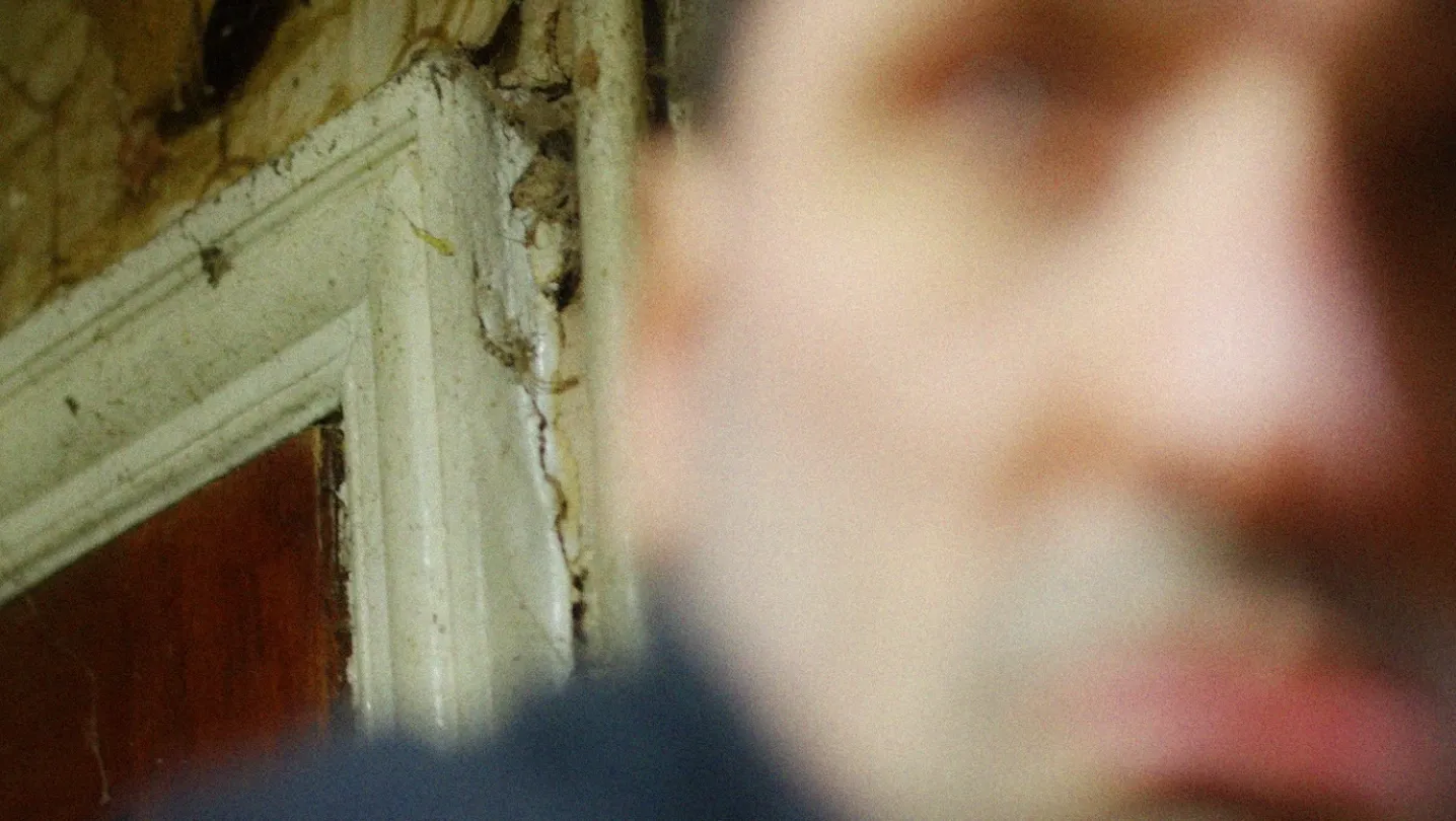 Out of focus man in a rundown kitchen