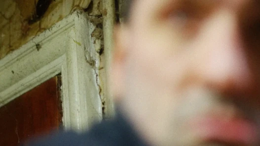 Out of focus man in a rundown kitchen