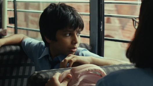 A young boy seated in a bus