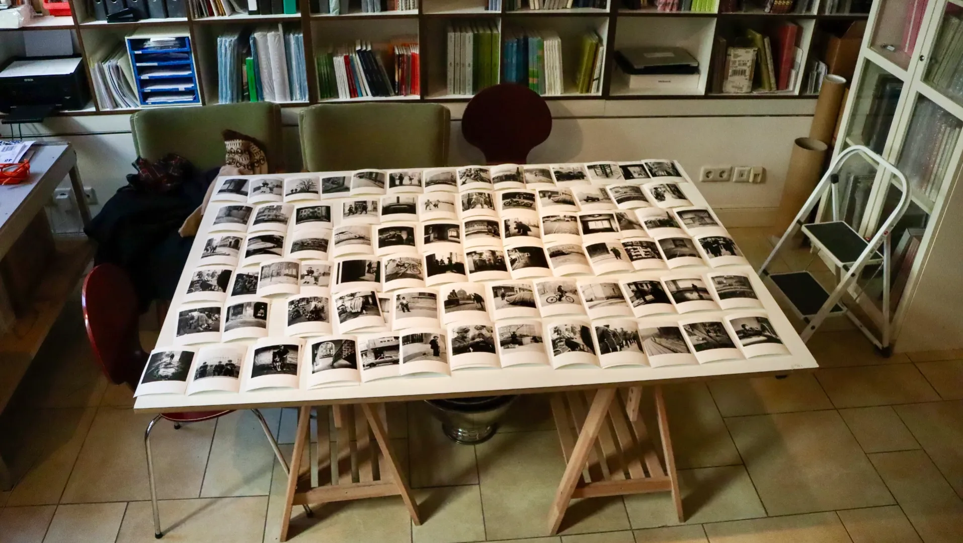Black and white individually printed photographs displayed on a white table