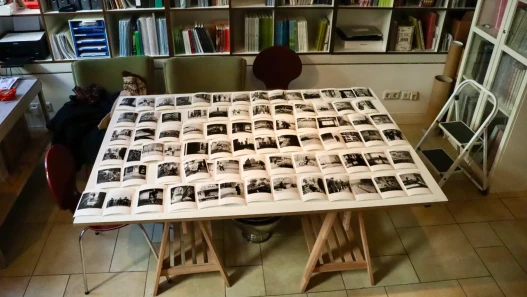 Black and white individually printed photographs displayed on a white table