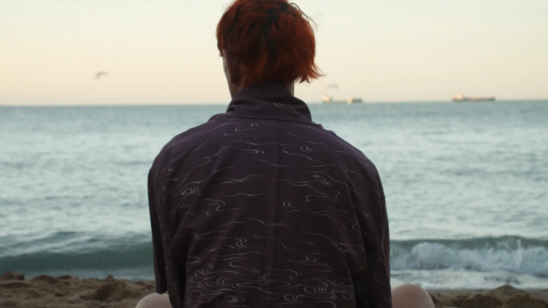 Portrait of Patrick Wolf looking out to sea