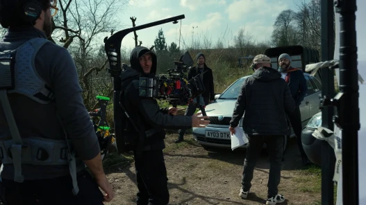 Cinematographer, director, sound recorder and two actors in the background