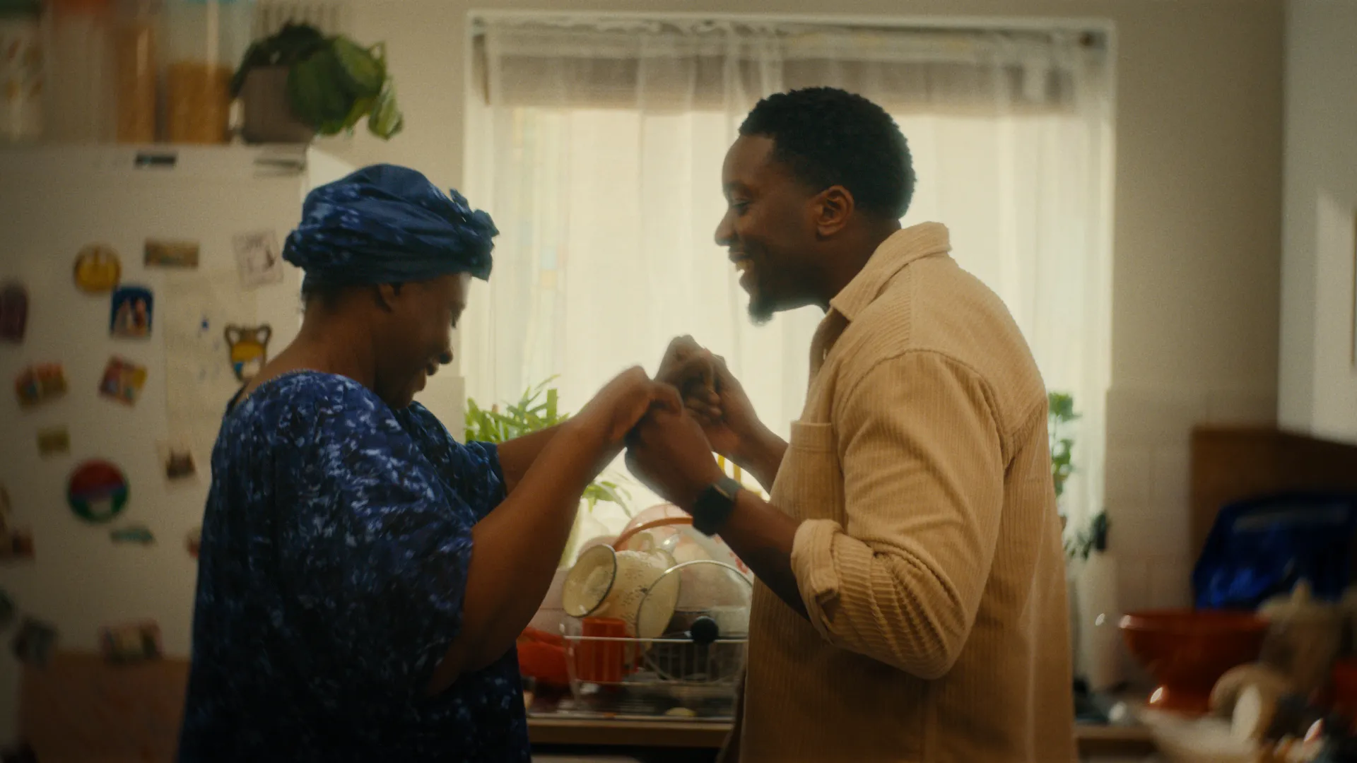Grandmother and grandson dancing in the kitchen