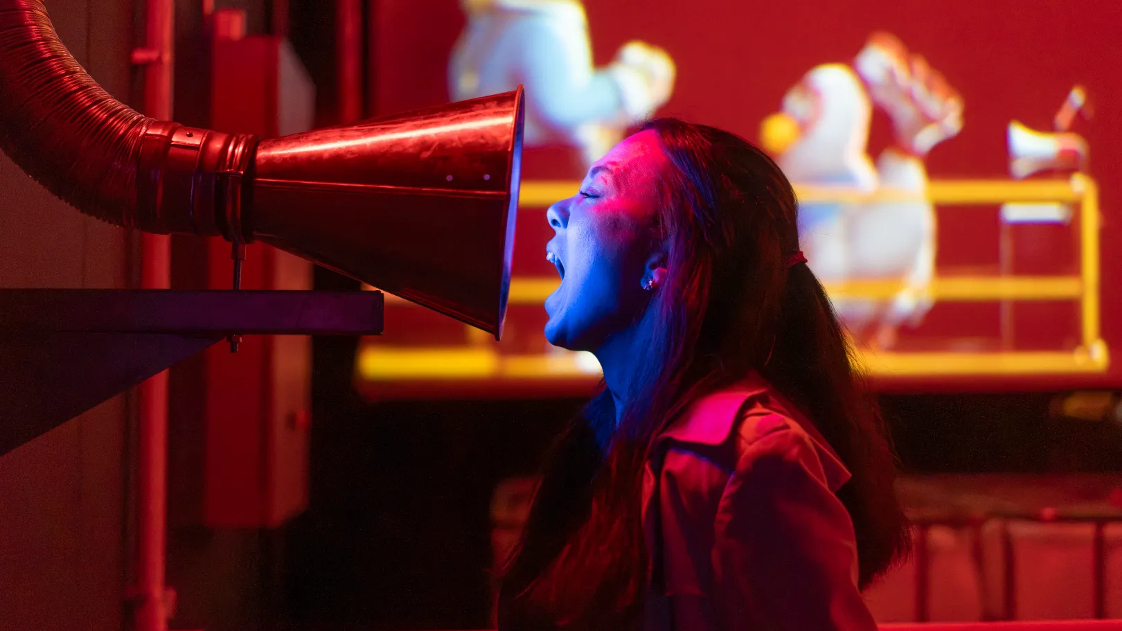 Factory Room at Marshmallow Laser Feast's show Sweet Dreams. A person screams into a Scream Cone from the side.