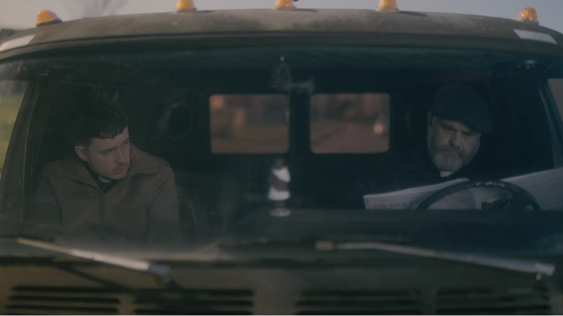 Two priests in a van.