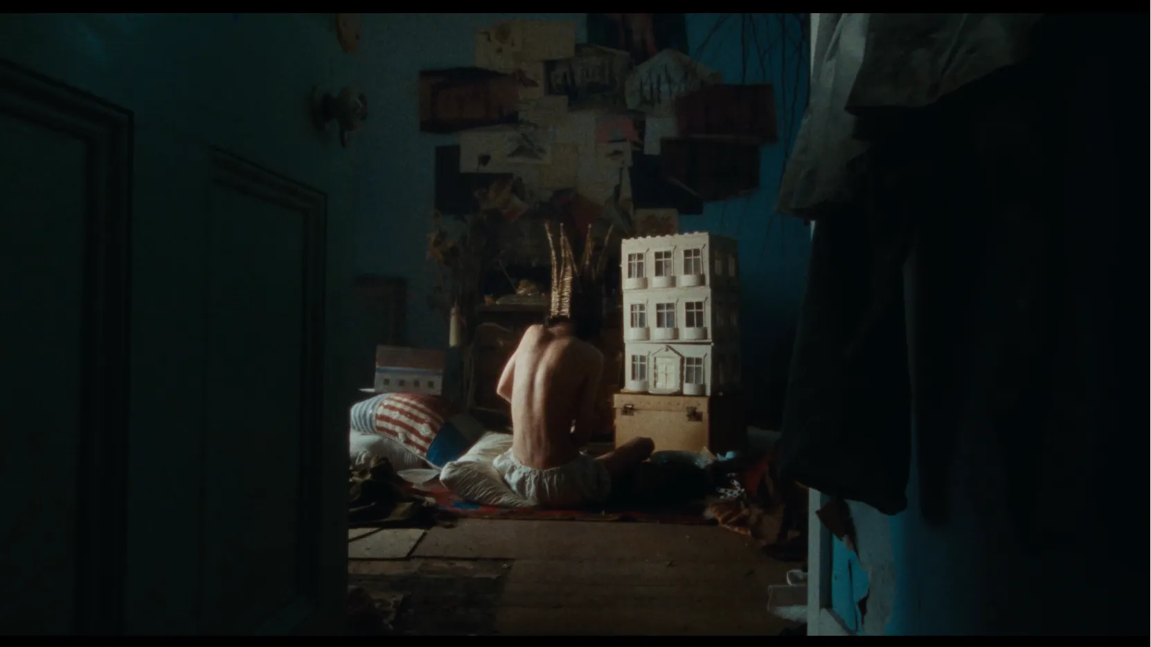 The Boy playing with his doll's house.