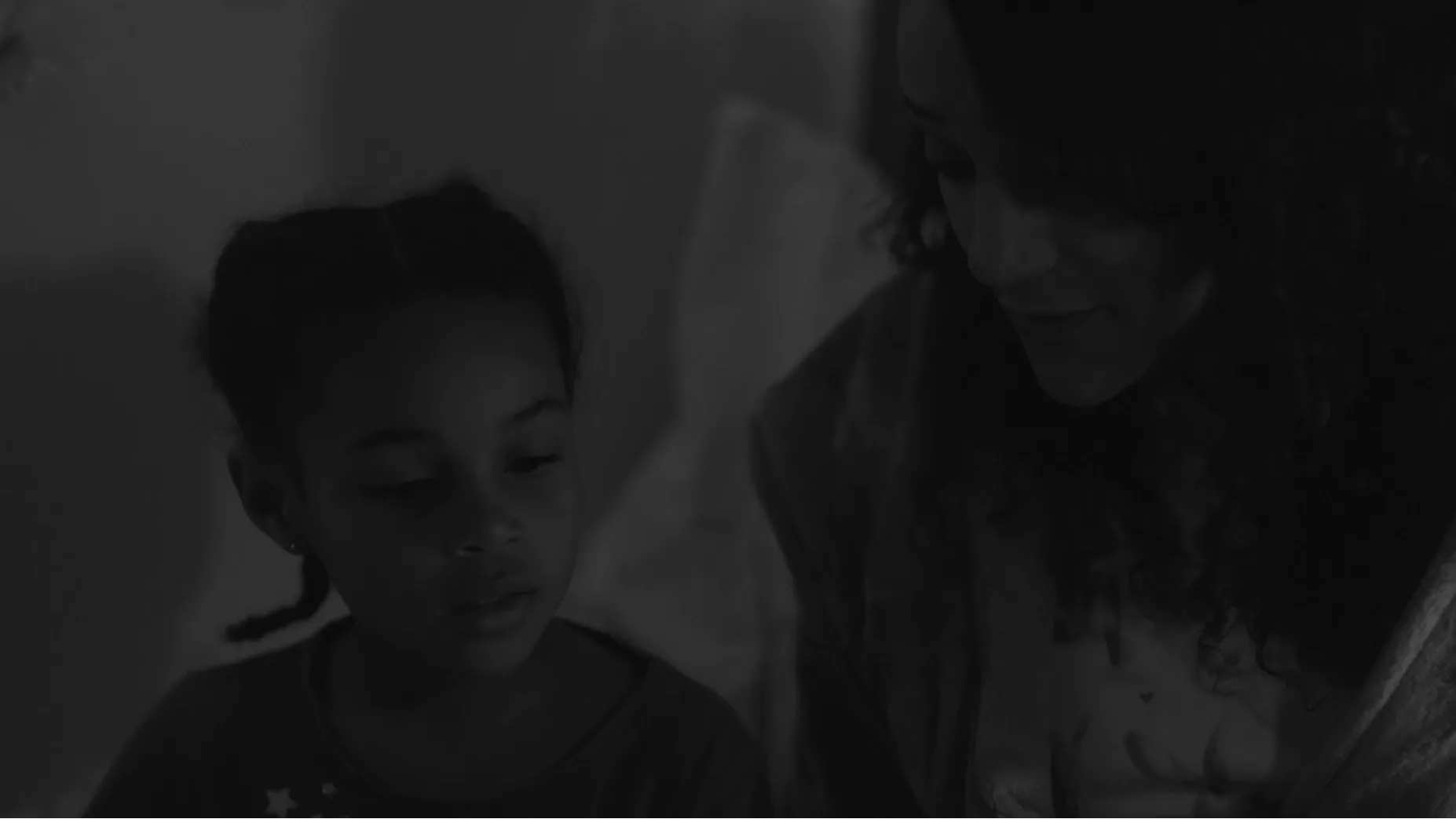 A woman is reading to a child.