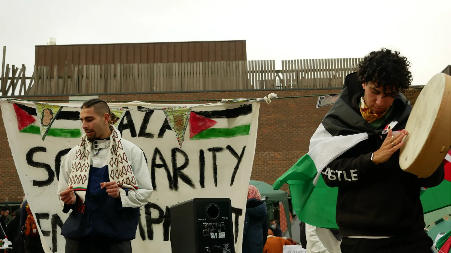 Palestinian student DJing alongside a tabla drummer at the Newcastle University encampment 2024.