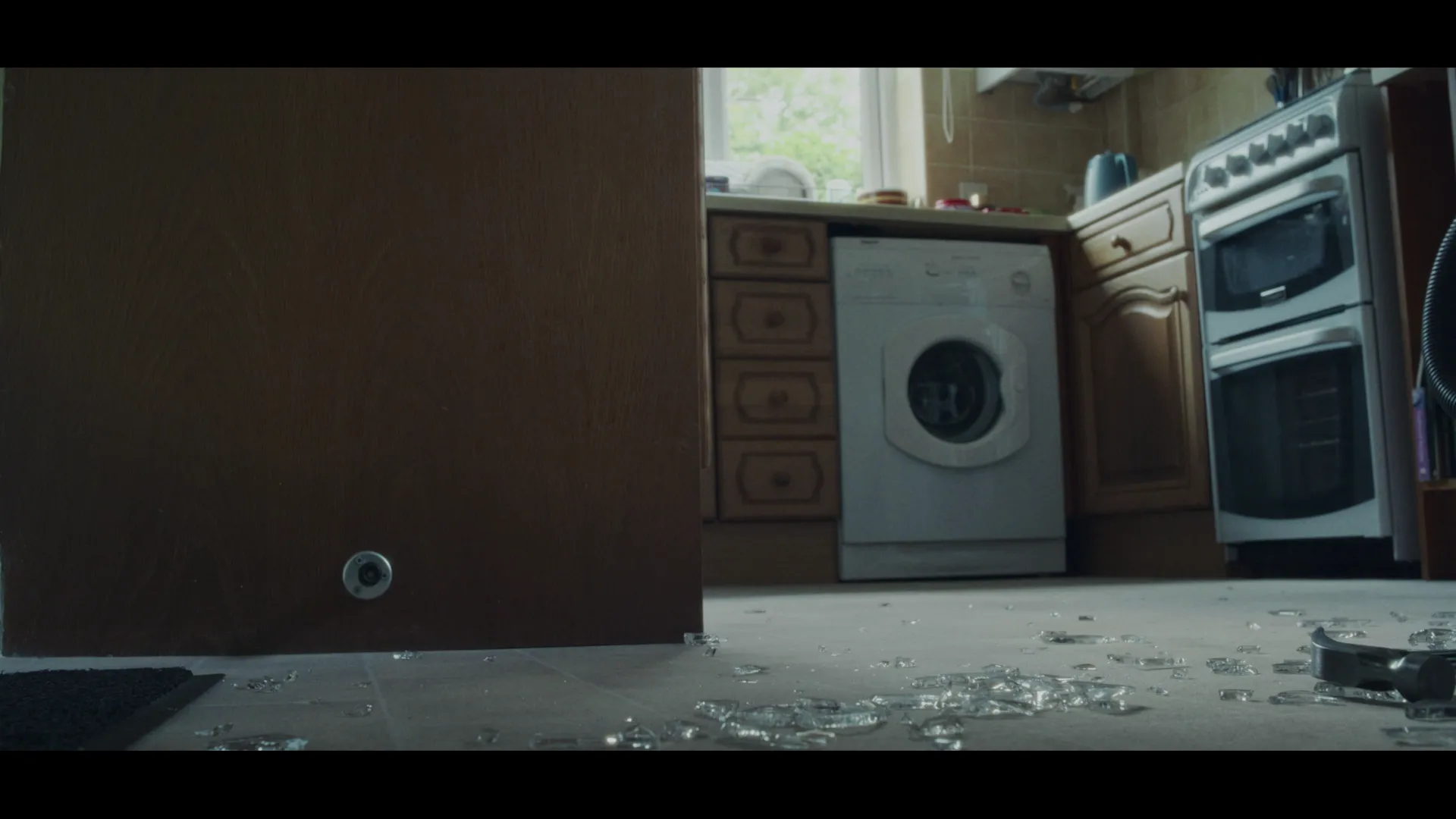 A broken window with a hammer.