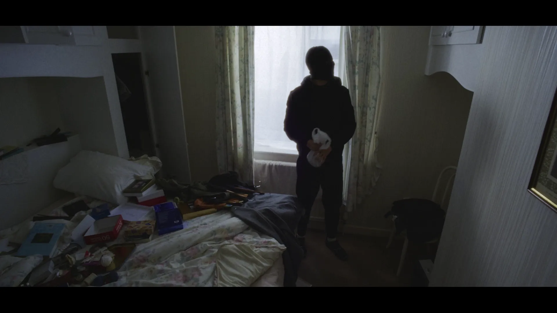 The burglar looking at a cupboard.