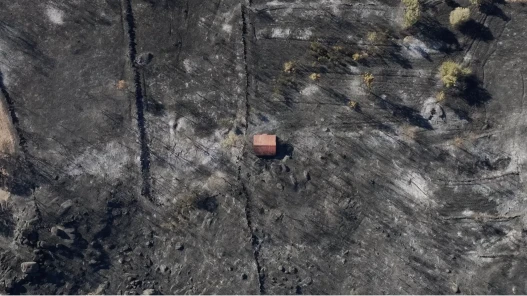 A high overhead shot of house after a wildfire