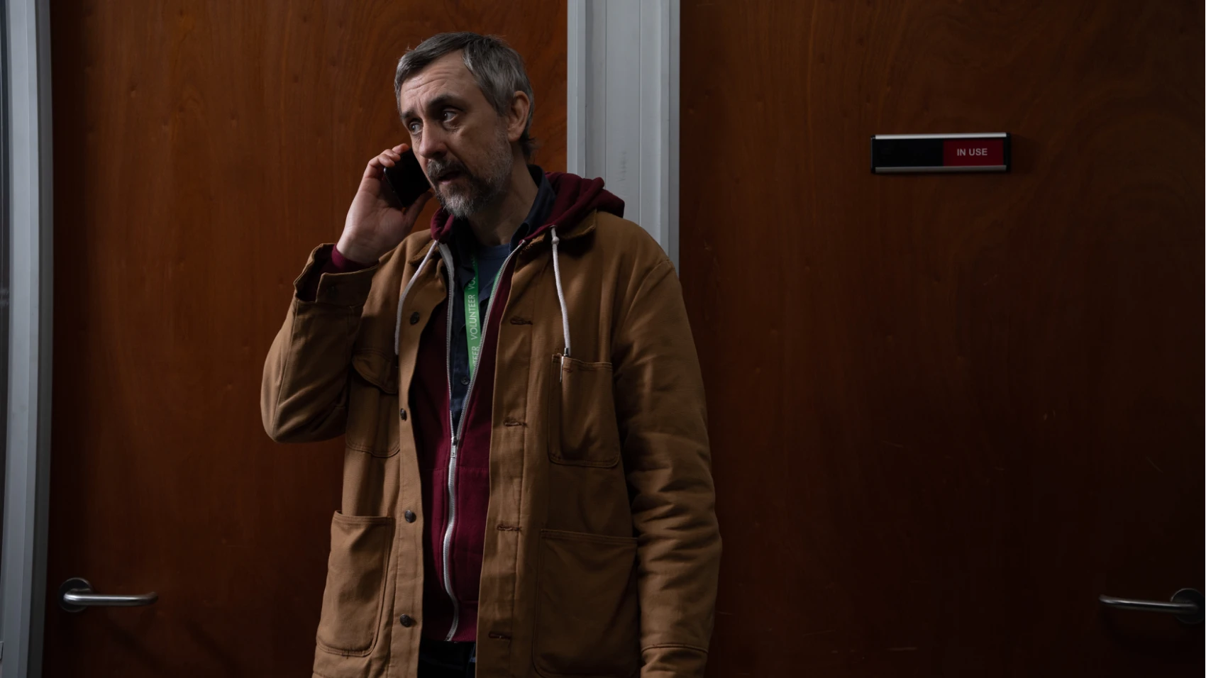 A man is taking a call on a mobile phone