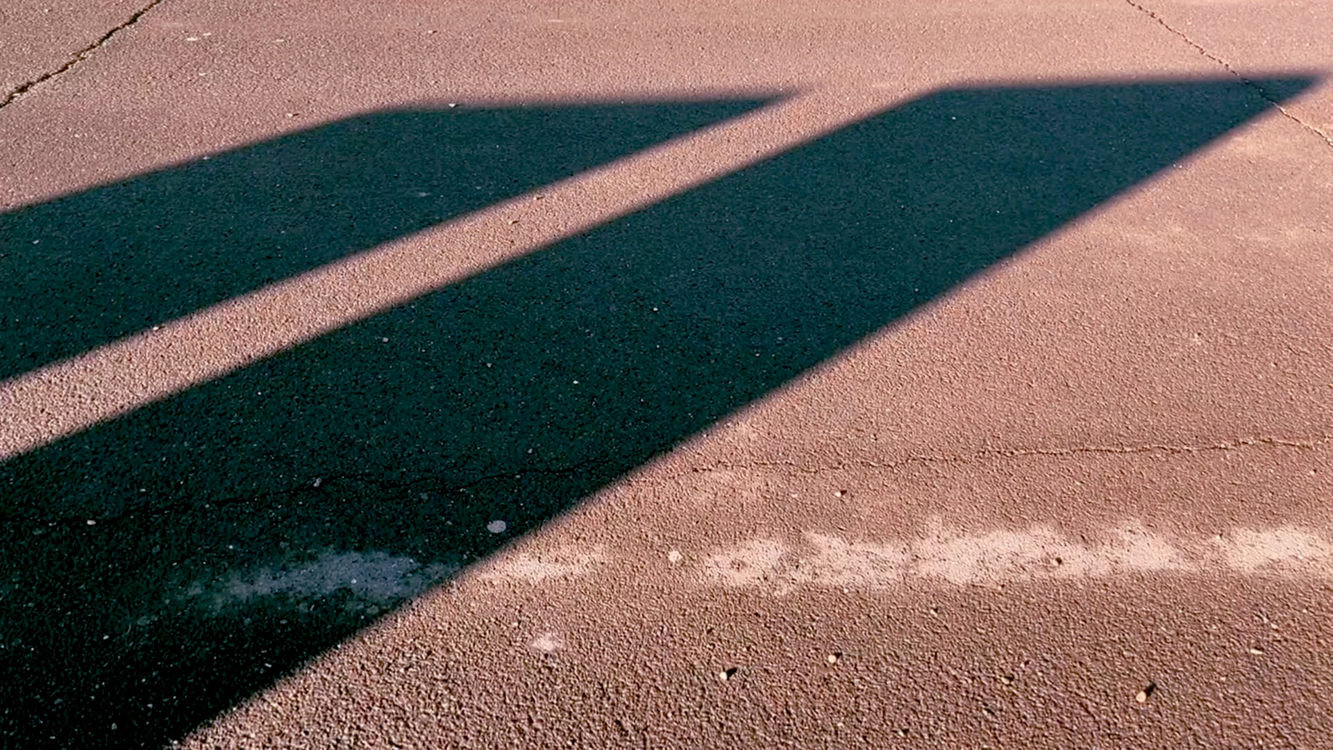 Two angular shadows on a pavement