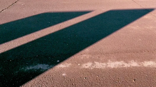 Two angular shadows on a pavement