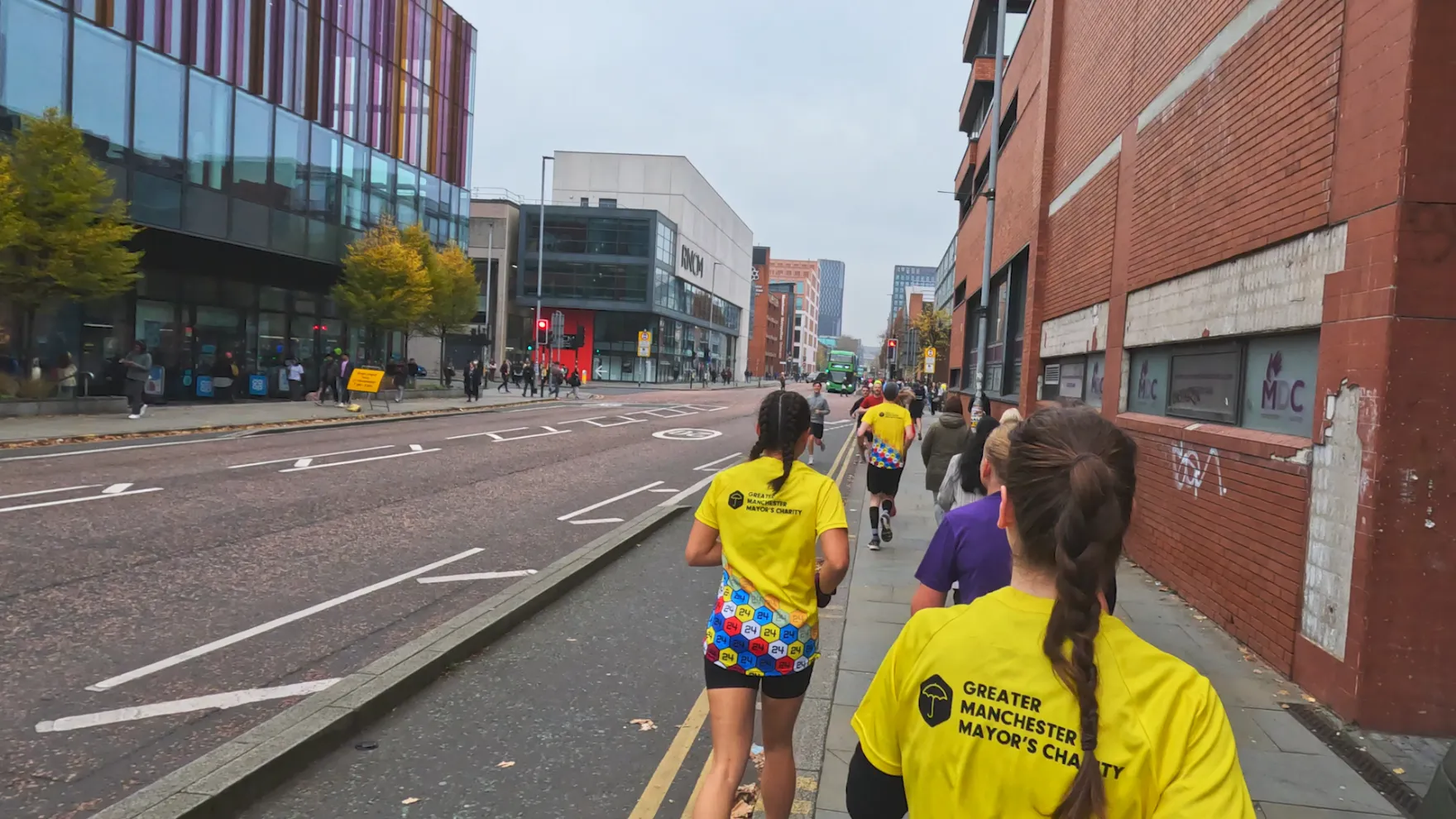 Runners running on Oxford Road, Manchester