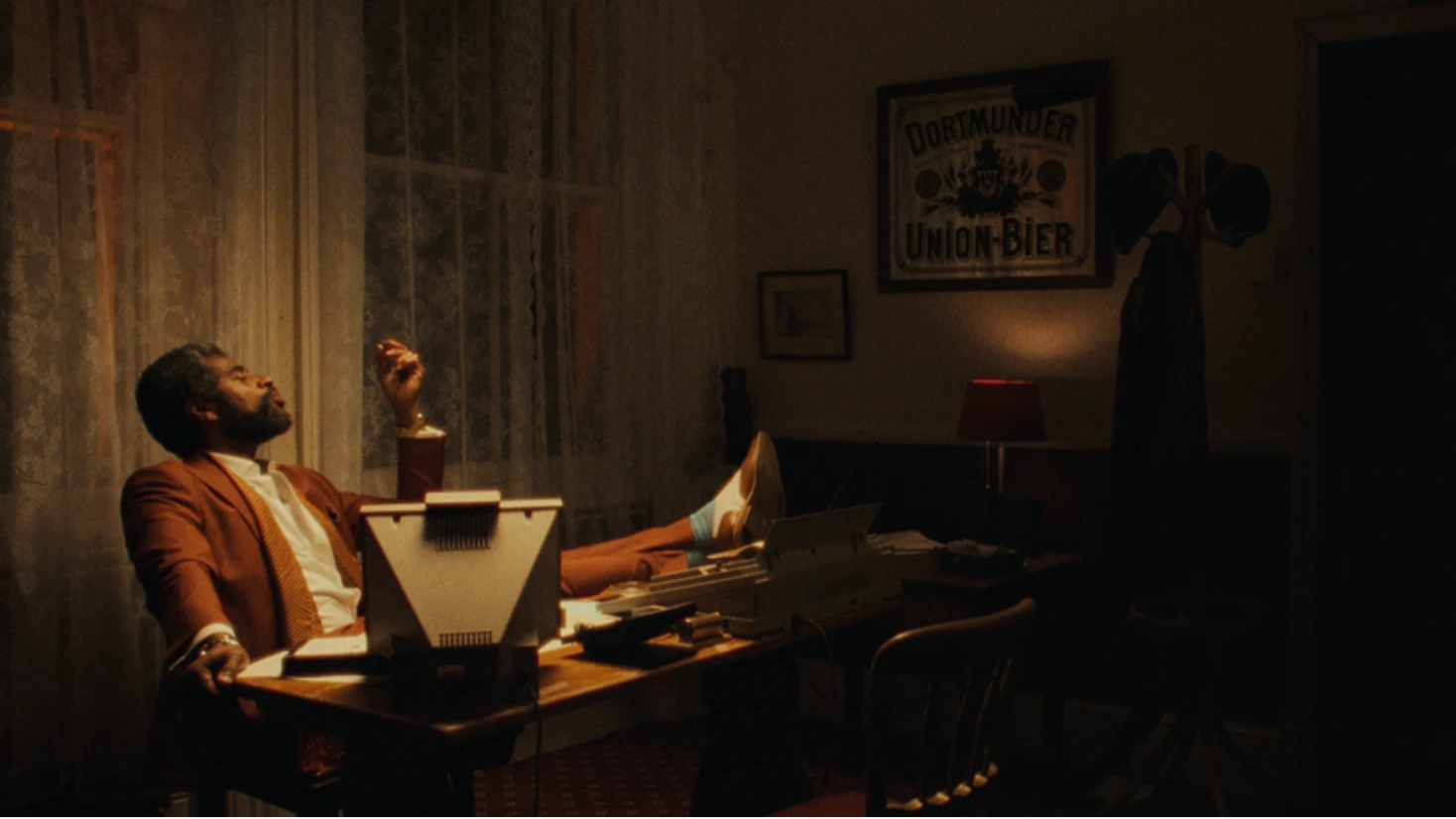 A man sitting in a 1990s office