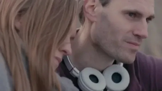 A woman and man sit side by side.