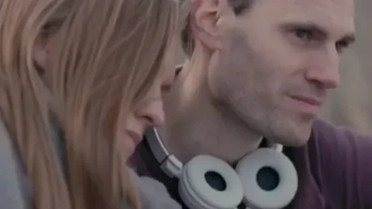 A woman and man sit side by side.