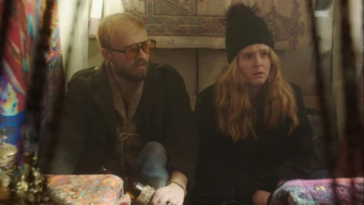 Two people sit in a bus