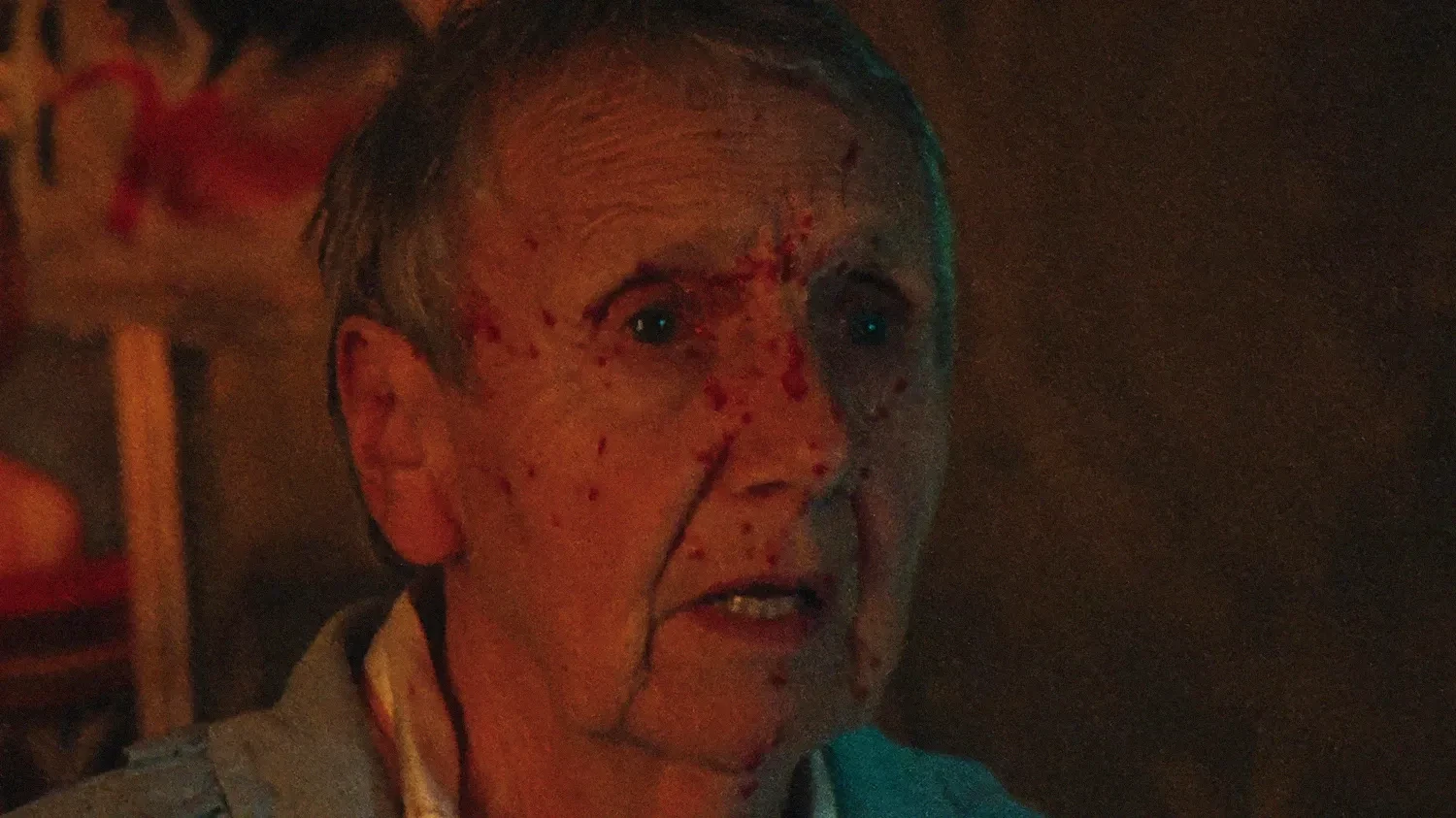 An old woman's face splattered with blood