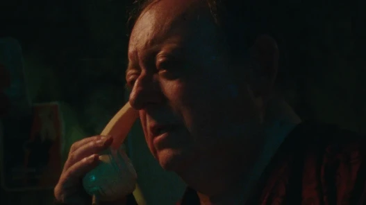 A middle-aged man holds a phone to his ear