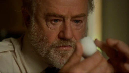 An older man examines an egg shell