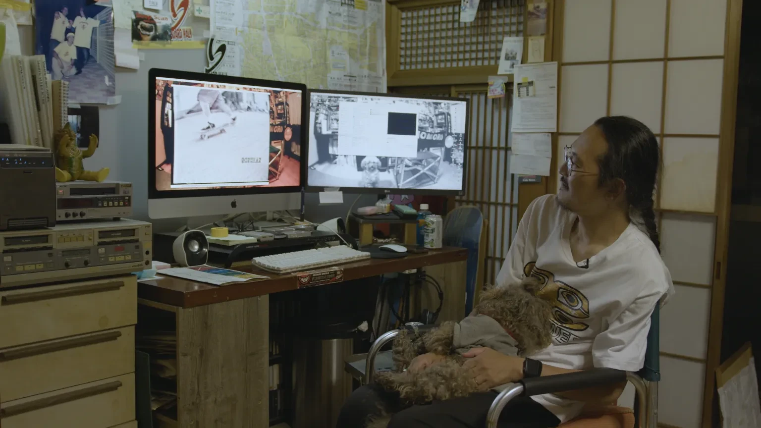 A man watching his archival skating footage