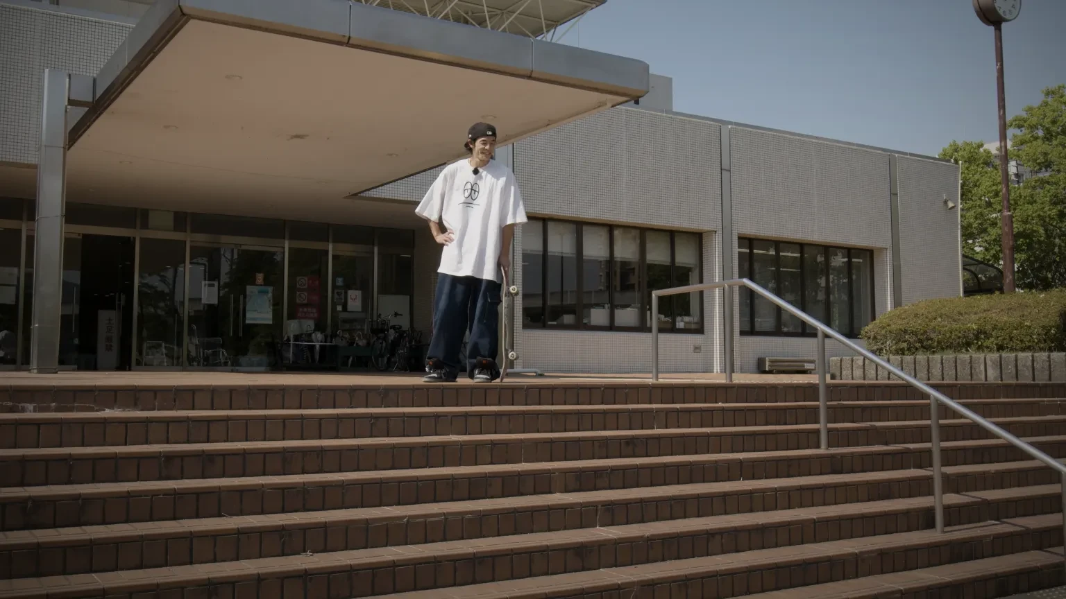 A skateboarder preparing to skate down a flight of steps