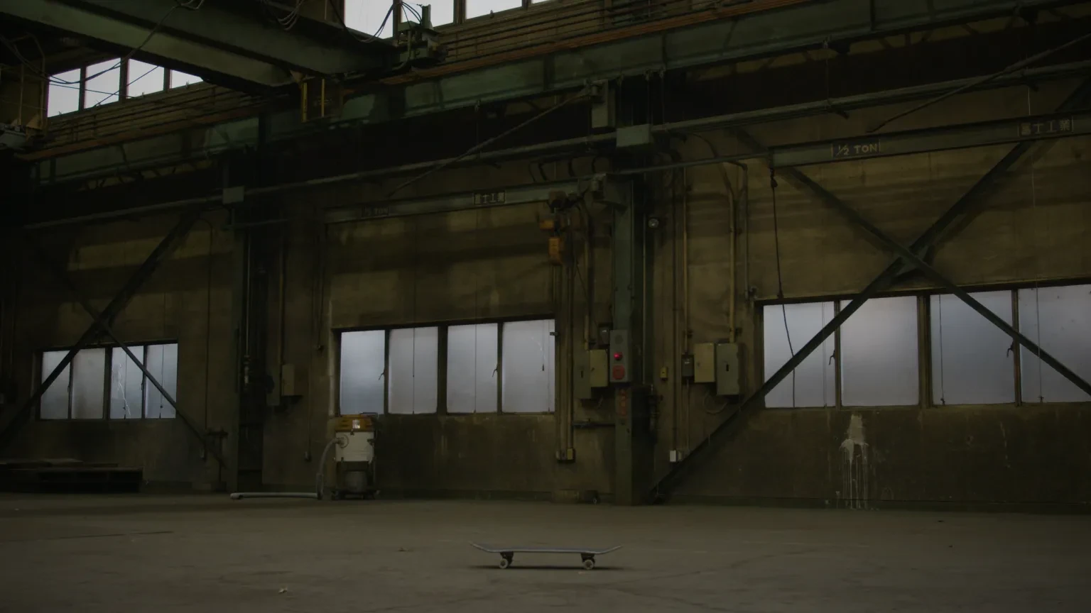 An upturned skateboard in a warehouse