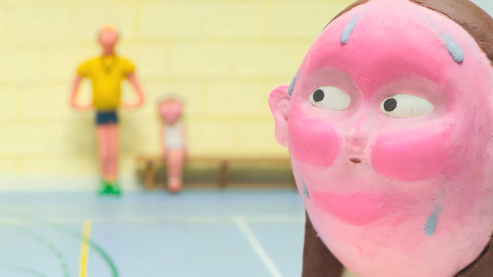 Close up of animated girl and two figures blurred in the background - one tall man in yellow t-shirt and blue shorts and a small child in white