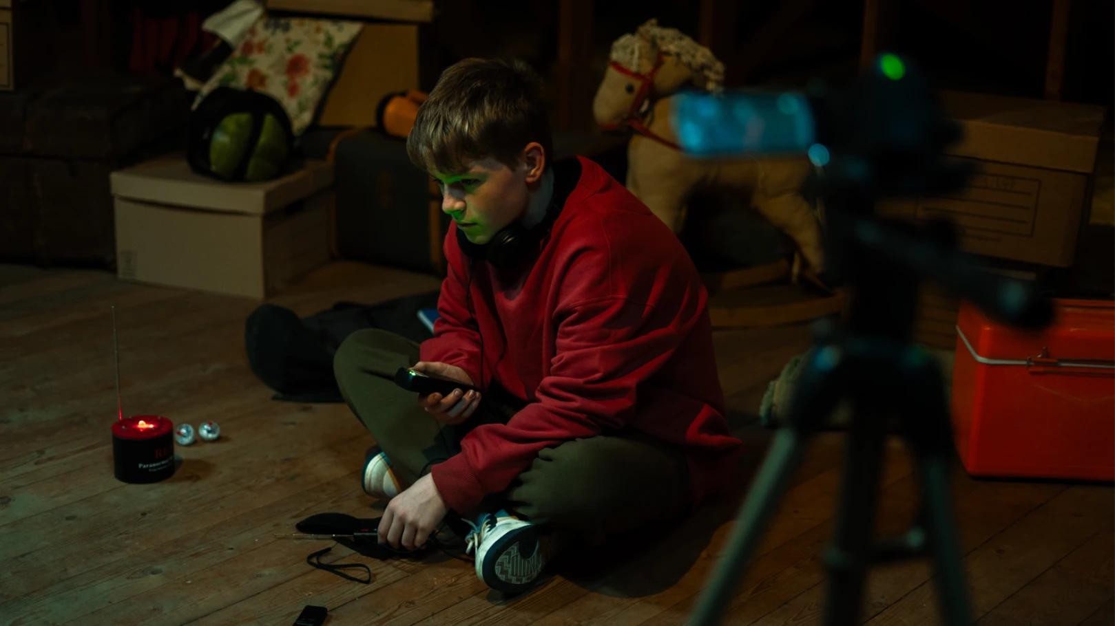 A young teenage boy ghost hunts in the attic