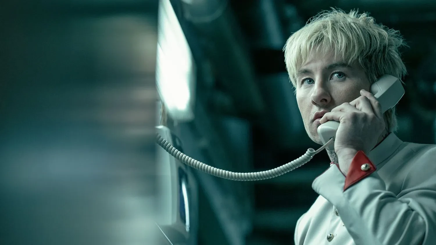 A blond man making a phone call