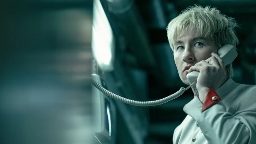 A blond man making a phone call
