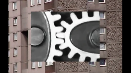 B/W gears against a block of flats