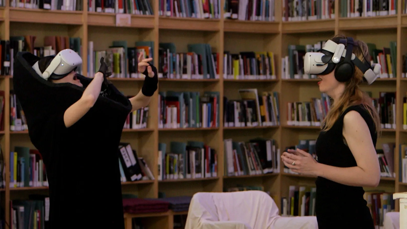 Performer and participant with VR headsets on yawn together during the performance.