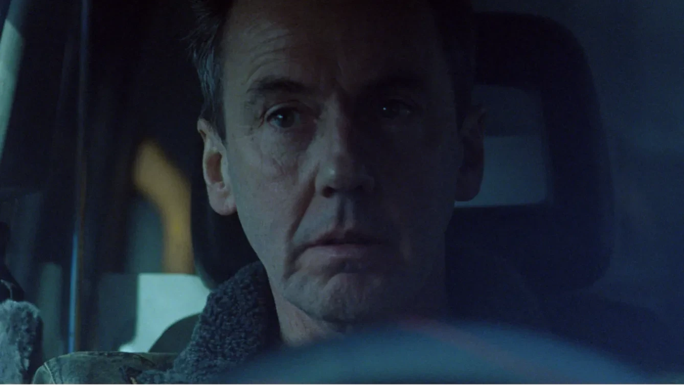 A can driver in a darkly lit close up