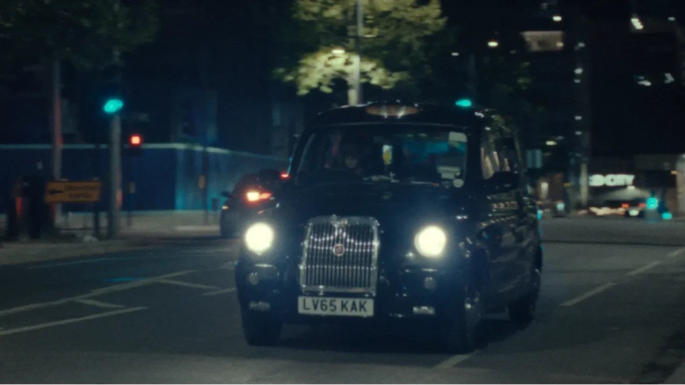 A London black cab at night time