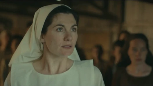 A nun staring off screen at a commotion.