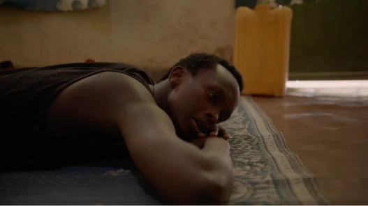 Main character from The Things We Don't Say lying on the ground, looking contemplative