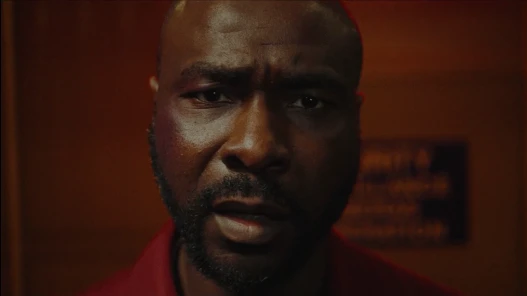 A disturbed looking man stares straight into the camera