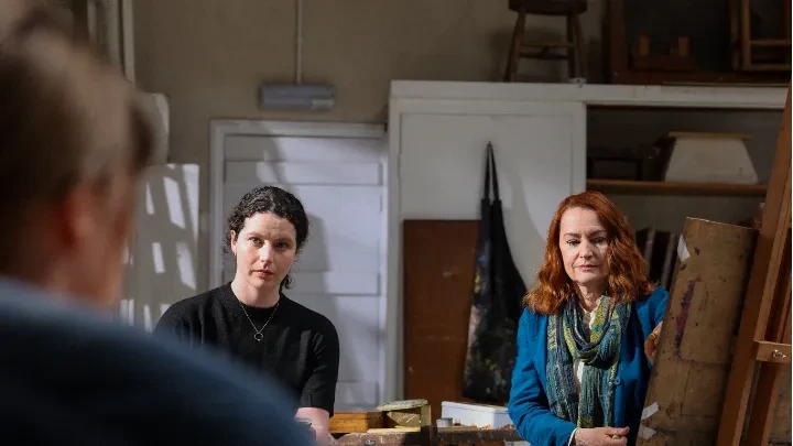 Two women observe a life model in a community art studio