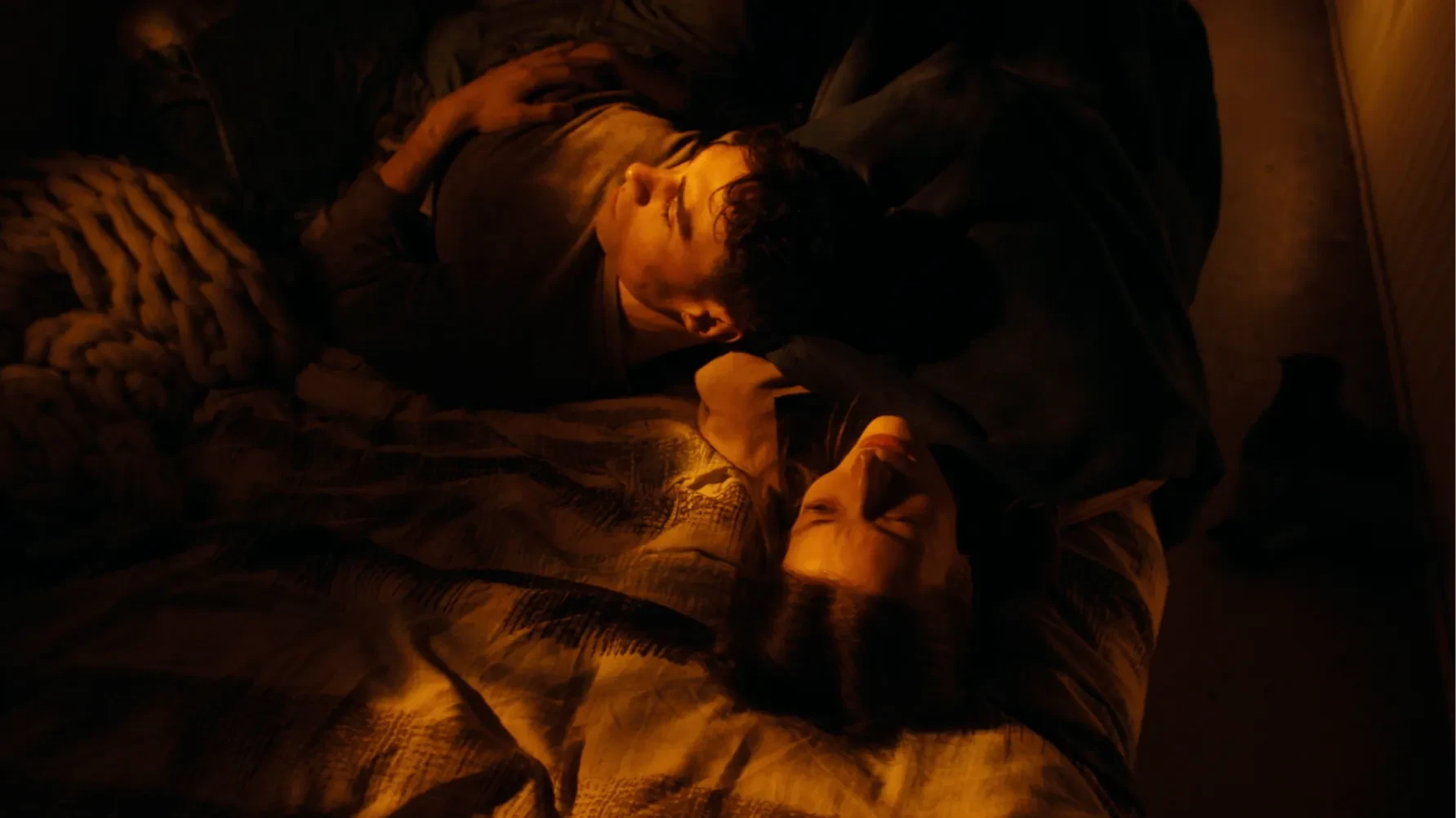 A couple like on a bed 